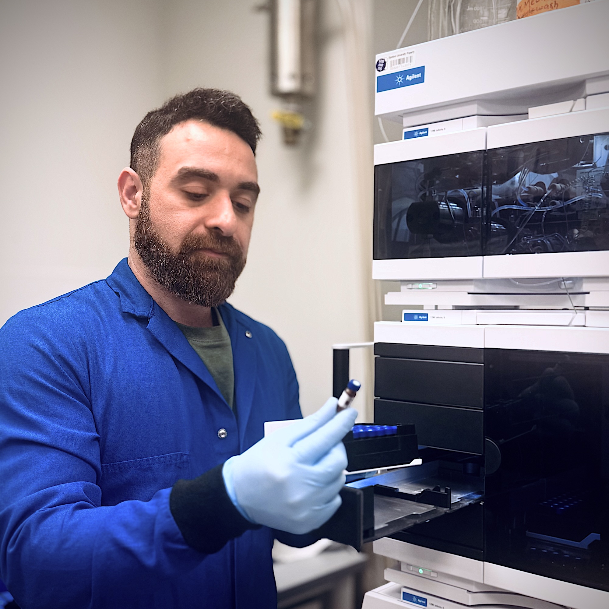 Ali Ghoochani examines samples in the lab. 