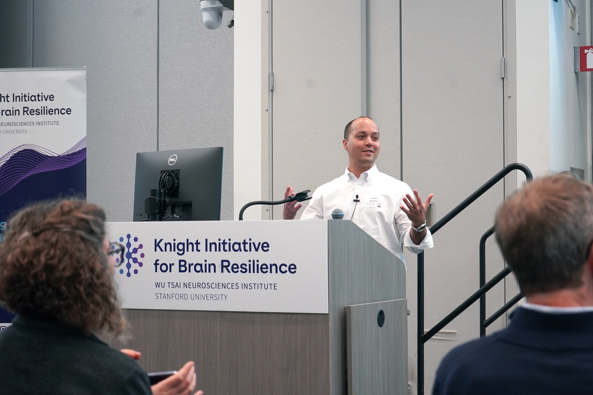James Olzmann speaks at a lectern.