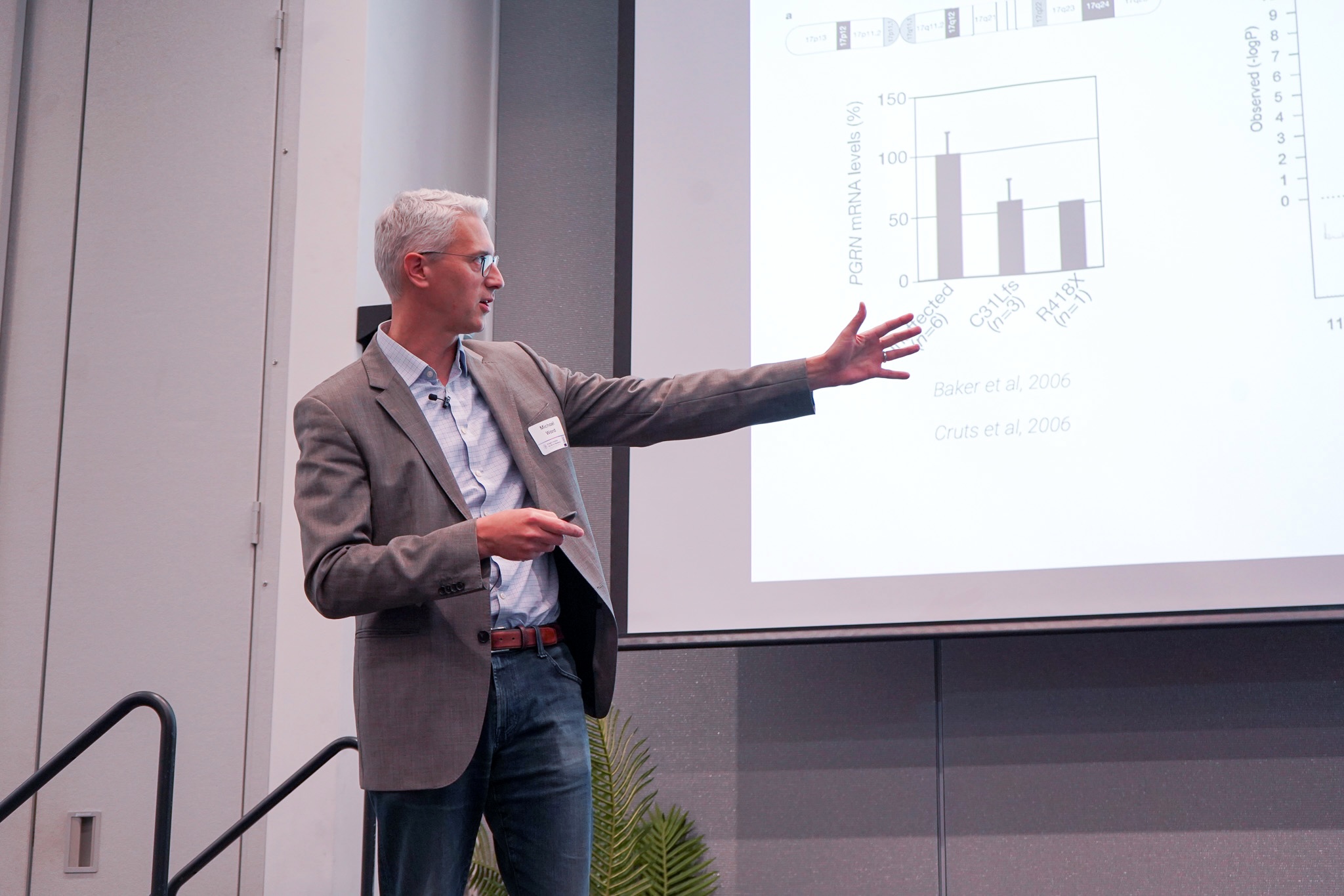 Michael Ward gestures to a slide presentation. 