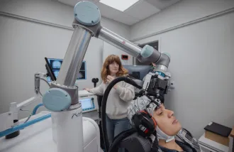 Milena Kaestner conducts TMS study in Koret Human Neurosciences Lab
