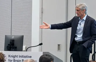 Frank Longo speaks in front of an audience