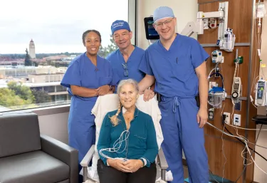 Debbie Styles smiles with her surgical team. Standing, from left to right: Tiffany, a research coordinator for the CARDIAC-PND Study, Dr. Martin Angst, and Dr. Igor Feinstein. 