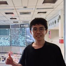 A headshot of Sangsin Lee, smiling and wearing a blue T-shirt. The background is simple and light gray, emphasizing a casual yet professional vibe.
